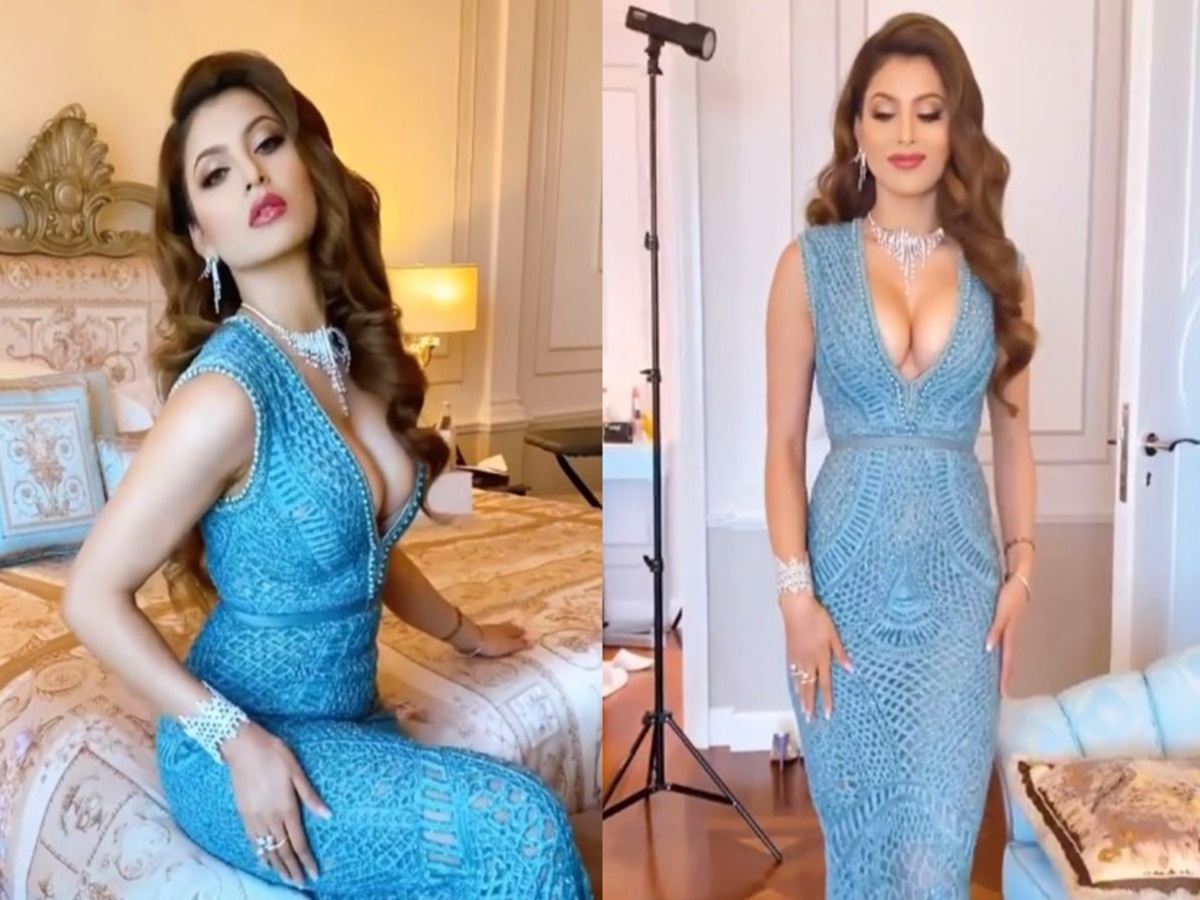 Urvashi Rautela poses in a striking, figure-hugging blue gown.