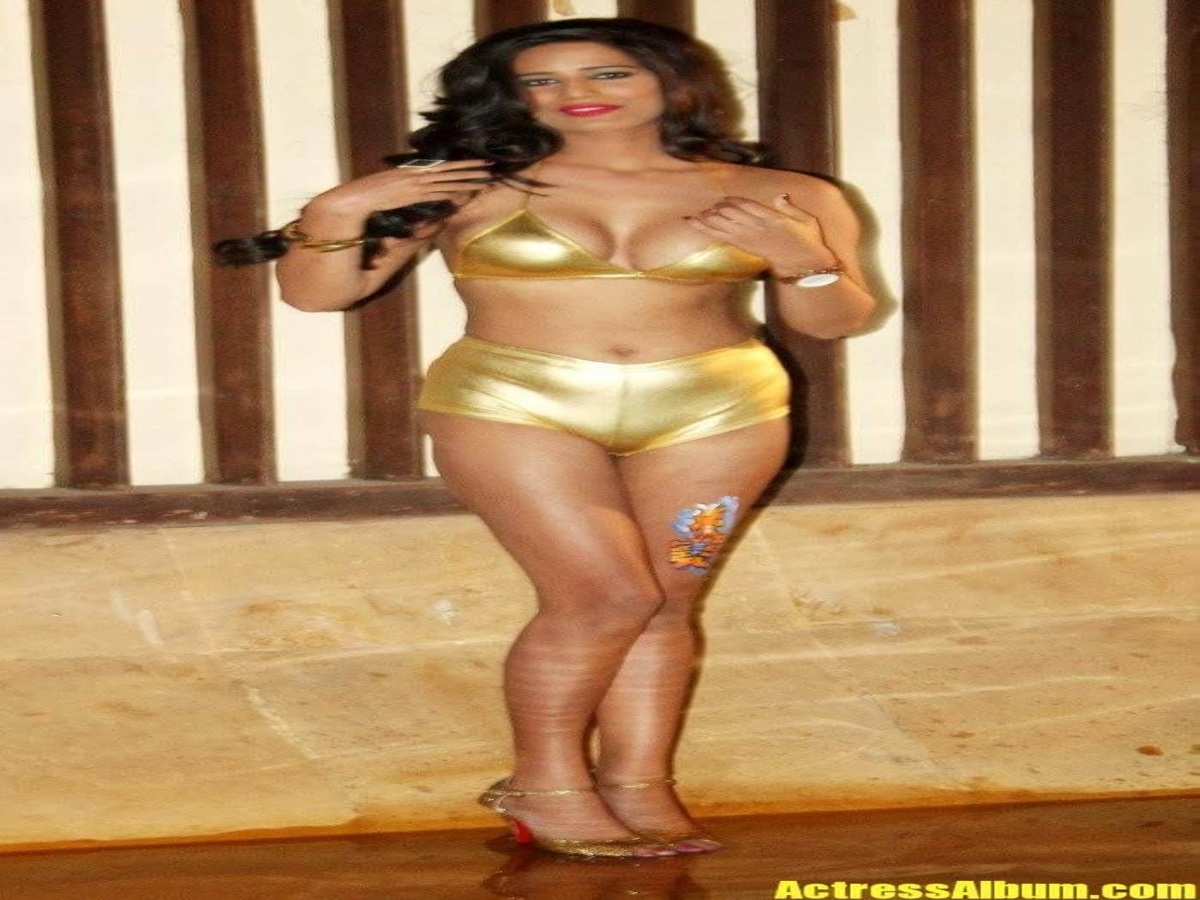 A model in a glamorous gold bikini posing at a stylish poolside, radiating elegance and confidence.