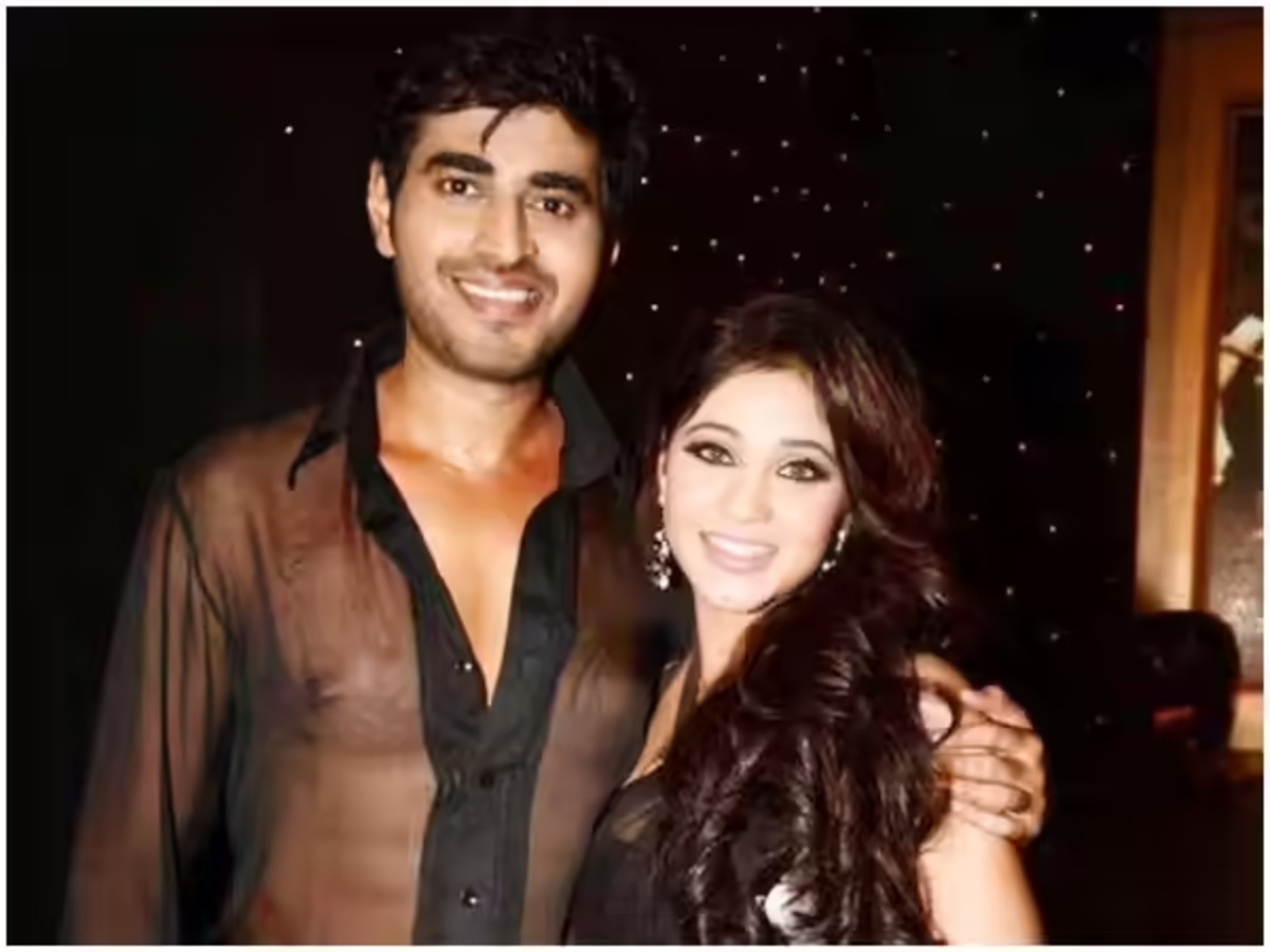 Amrapali Gupta kissing husband Yash Sinha during their vacation in the UK, capturing a romantic moment against a scenic backdrop.