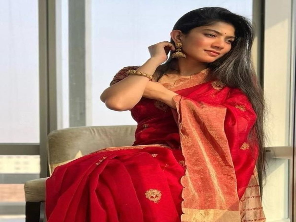 Actress in a beautiful red saree with intricate designs