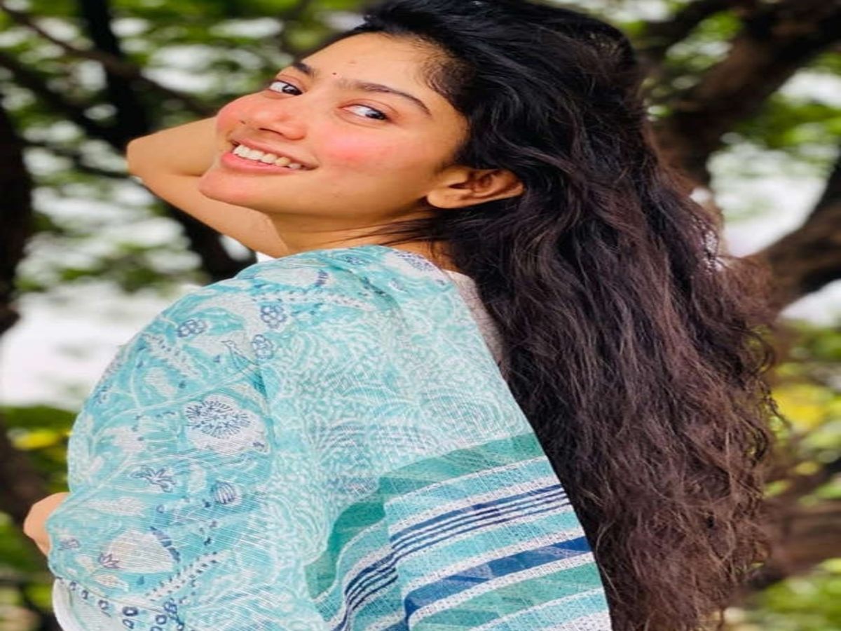 Actress in a charming blue saree amidst greenery