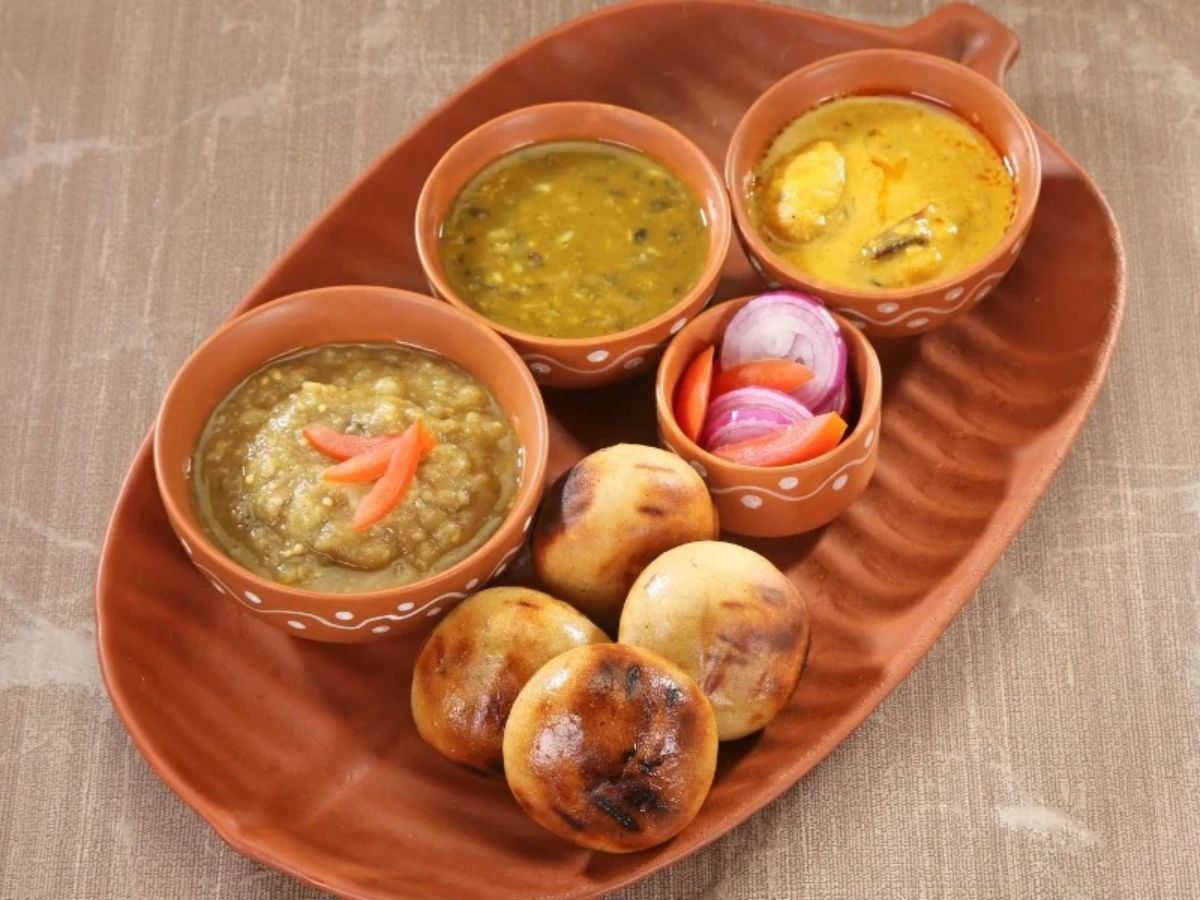 Smoky baati with chokha and ghee in Gorakhpur thali.