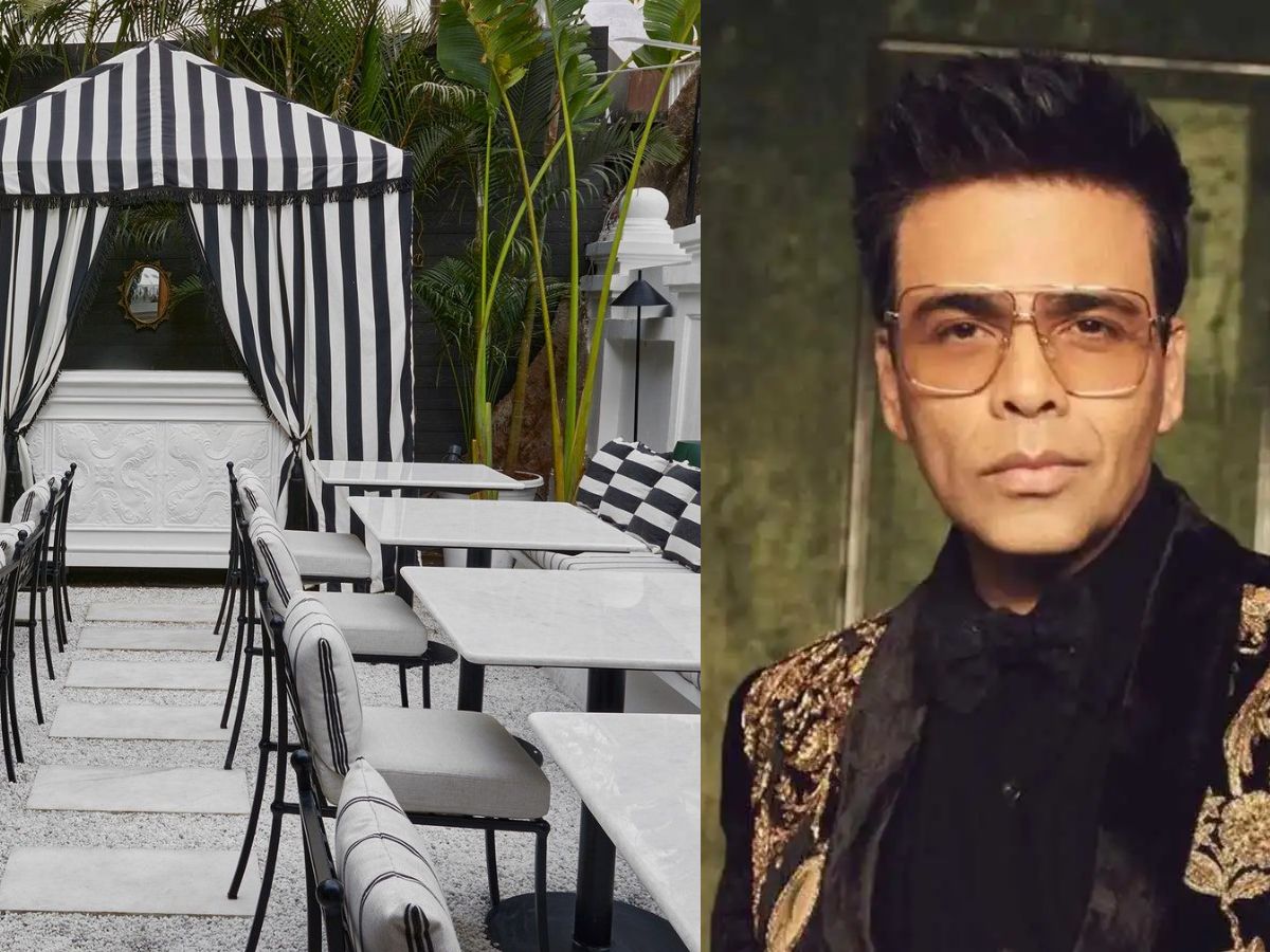 Chic outdoor dining with black-and-white striped cabana, surrounded by tropical plants and elegant monochrome furniture.