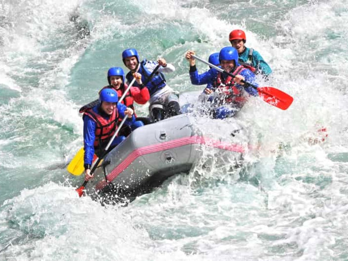 Rafting group conquering white water rapids on Barapole River, Coorg