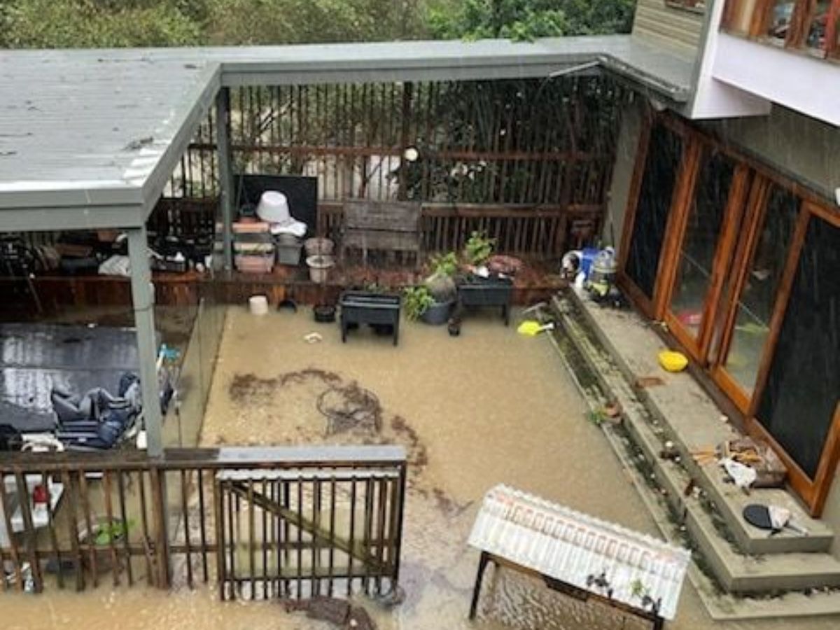 Texas house nearly flooded as brown water spreads across the yard.