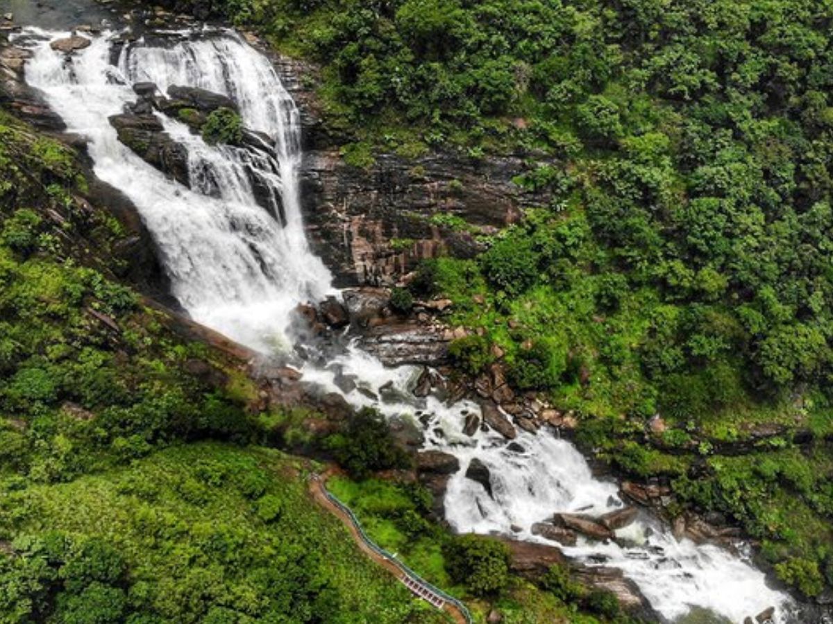 Mallalli Falls cascading over rocks amid dense Western Ghats greenery.
