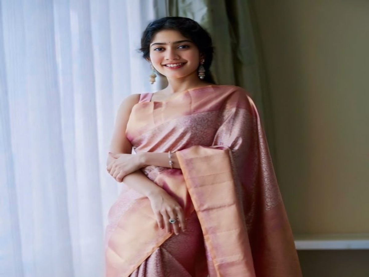 Model in a graceful soft pink saree with elegant accessories