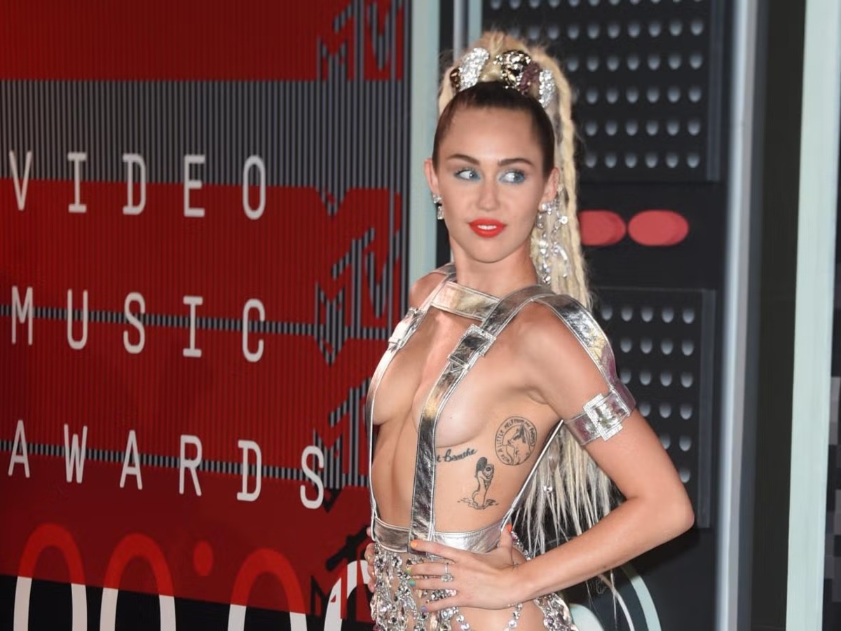 Miley Cyrus wearing a sequined bodysuit at the 2015 MTV VMAs, a controversial outfit that sparked plagiarism accusations.