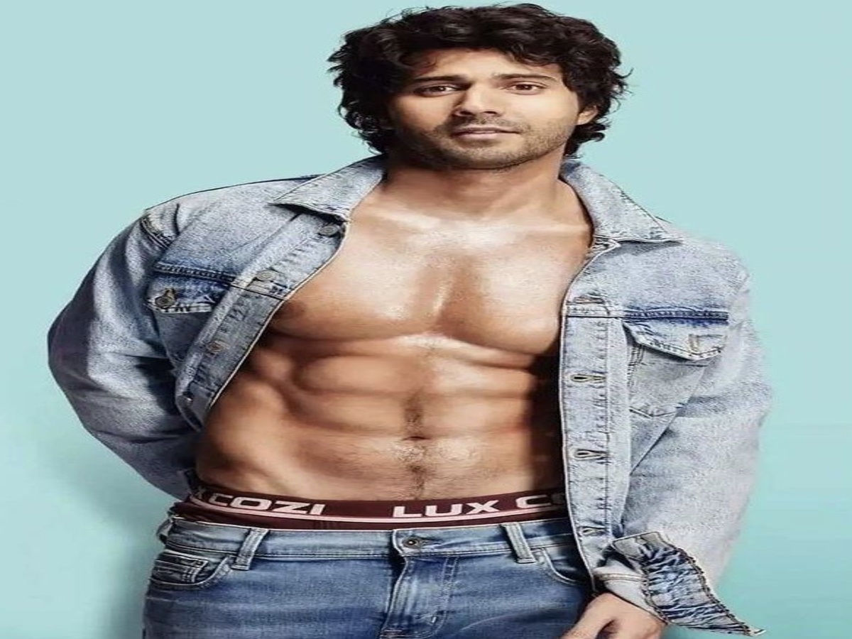 Varun Dhawan showcasing his toned abs, captivating fans and creating a stir on social media with his impressive physique.
