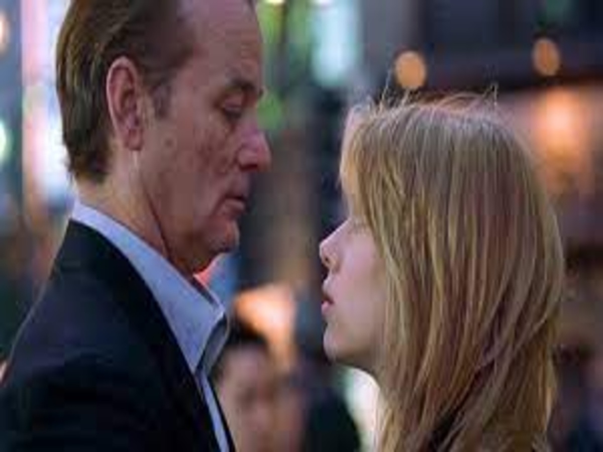 Bill Murray and Scarlett Johansson sharing an unscripted kiss in "Lost in Translation," showcasing a genuine and spontaneous connection that enhances the emotional impact of the scene.