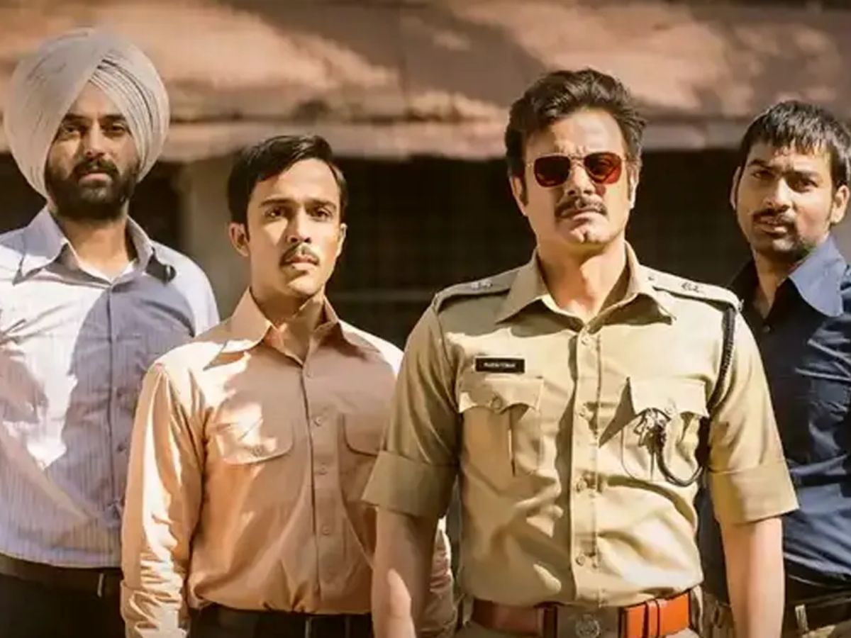 Cast of Black Warrant with lead actor in uniform, flanked by team members in casual attire.