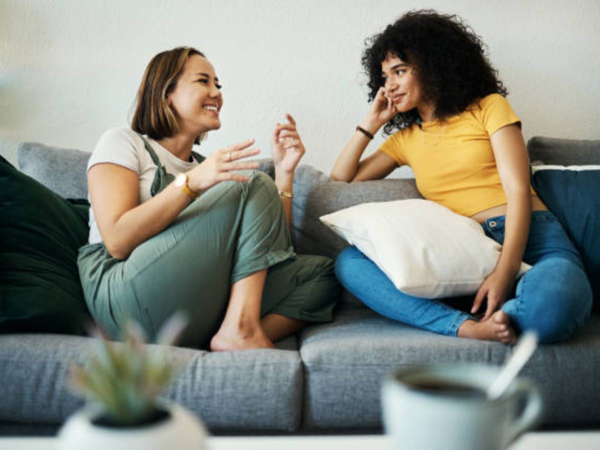 Two people sitting together, having an open and comforting conversation.
