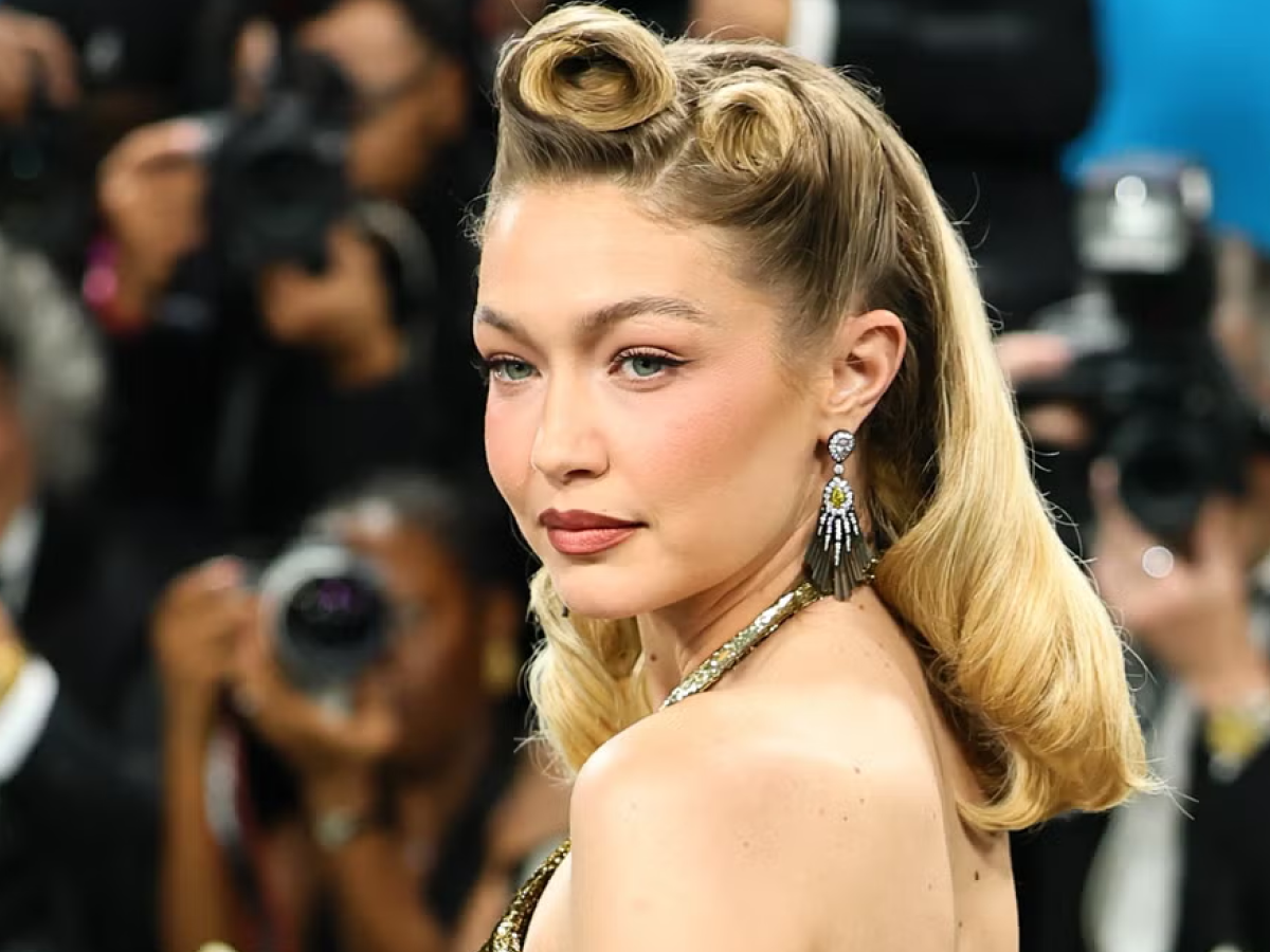 Gigi Hadid glows in a backless gold masterpiece