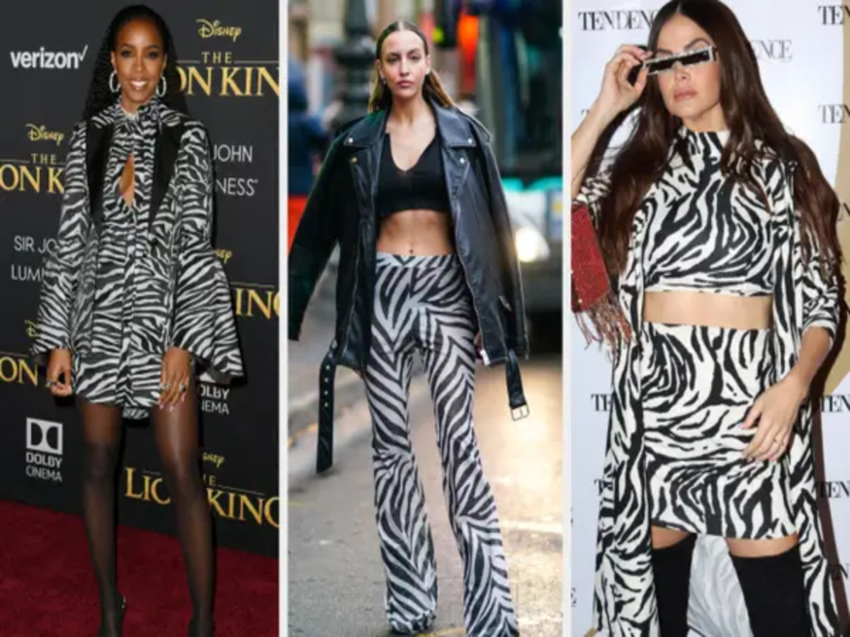 A pair of zebra print jeans displayed on a rack.