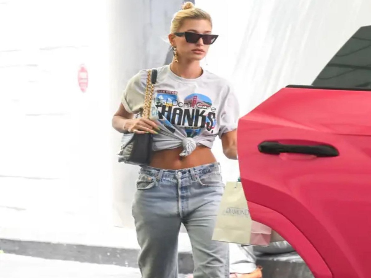 A stylish pair of modern cowboy boots displayed on a wooden surface.