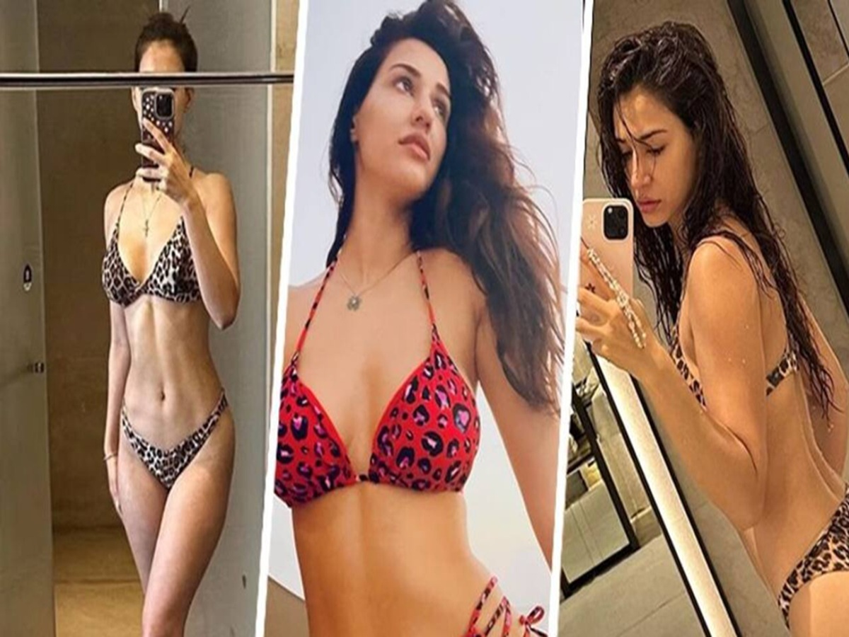Disha Patani takes a mirror selfie in a leopard-print bikini, flaunting her toned figure in a bathroom setting.