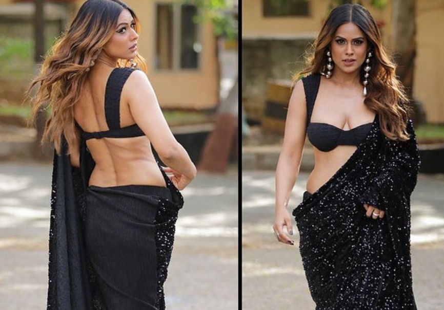TV actress in a black saree with off-shoulder blouse, showcasing her fierce style.