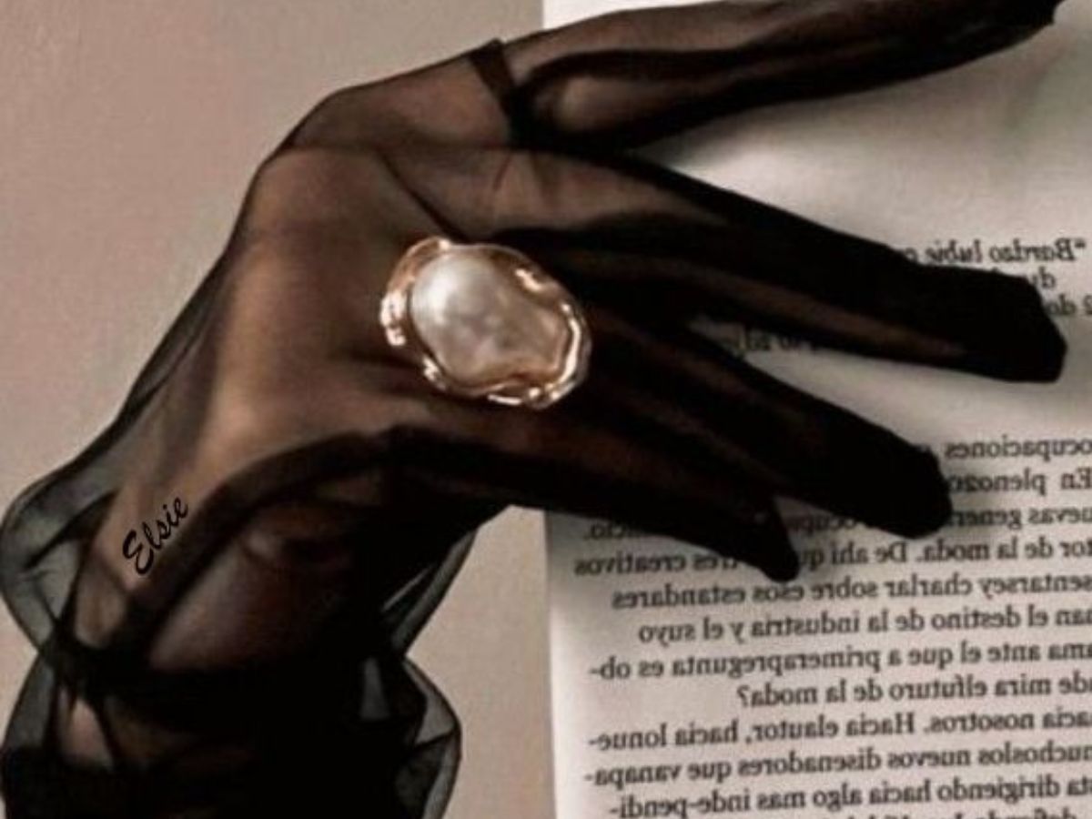 Woman styling a dark feminine outfit in black for a bold, expensive look