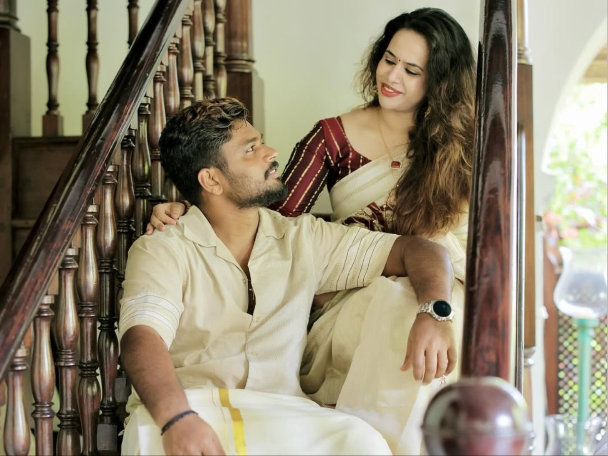Charulatha Remesh smiling and cheering from the grandstand during a high-stakes T20 match