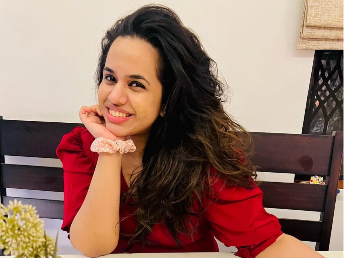 Charulatha Remesh dressed in sophisticated smart-casual wear for a public event with Sanju